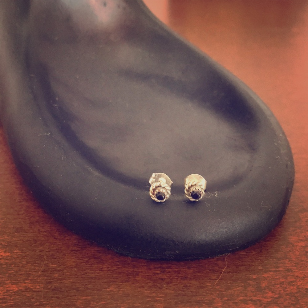 Hand-carved silver and onyx studs.
